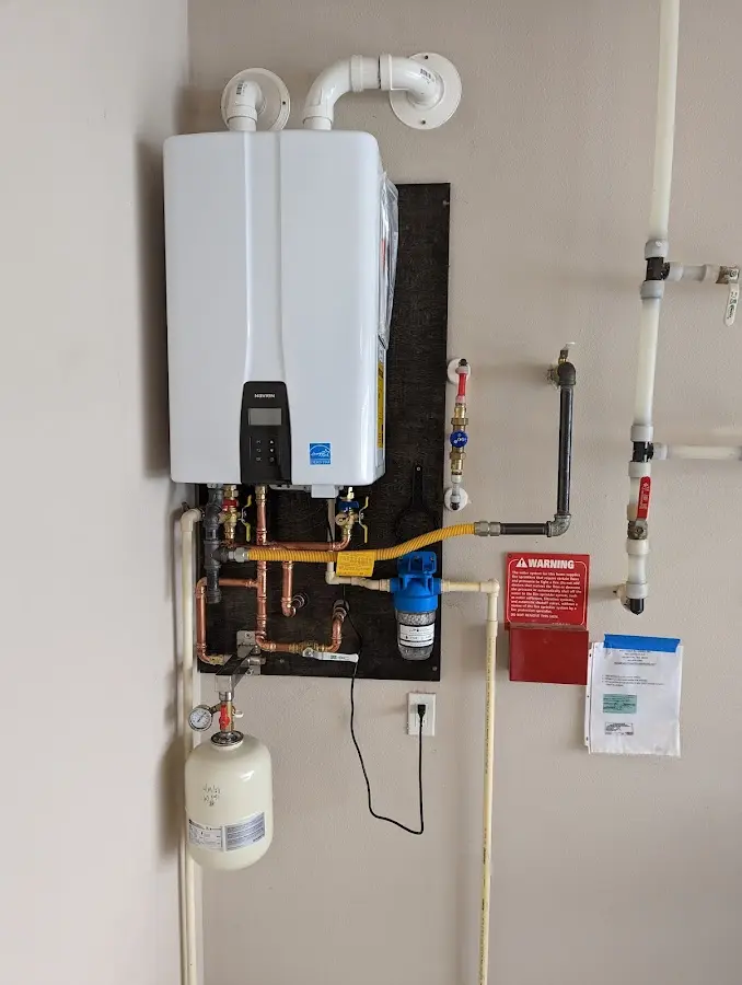 Professional plumber installing copper piping in a Gulf Park Estates home